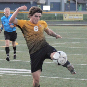 Male Viking soccer player kicking the ball.